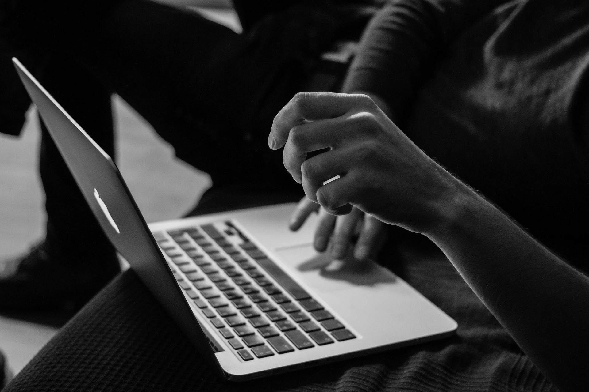 a person using a laptop computer sitting on top of a table